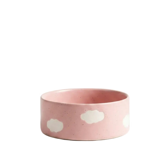 Pink ceramic bowl with cloud patterns on a beige background